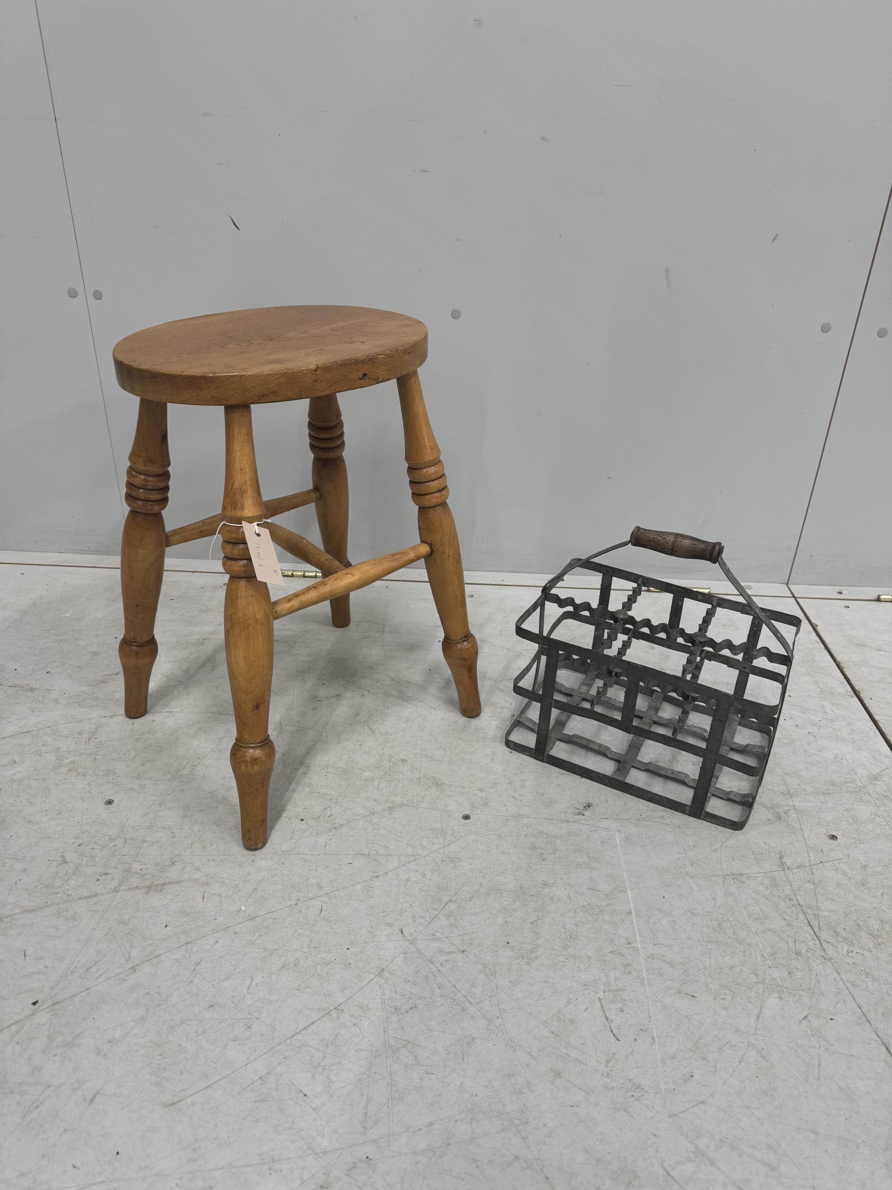 A Victorian elm and beech stool, height 52cm, together with a French galvanised six section bottle carrier. Condition - fair to good